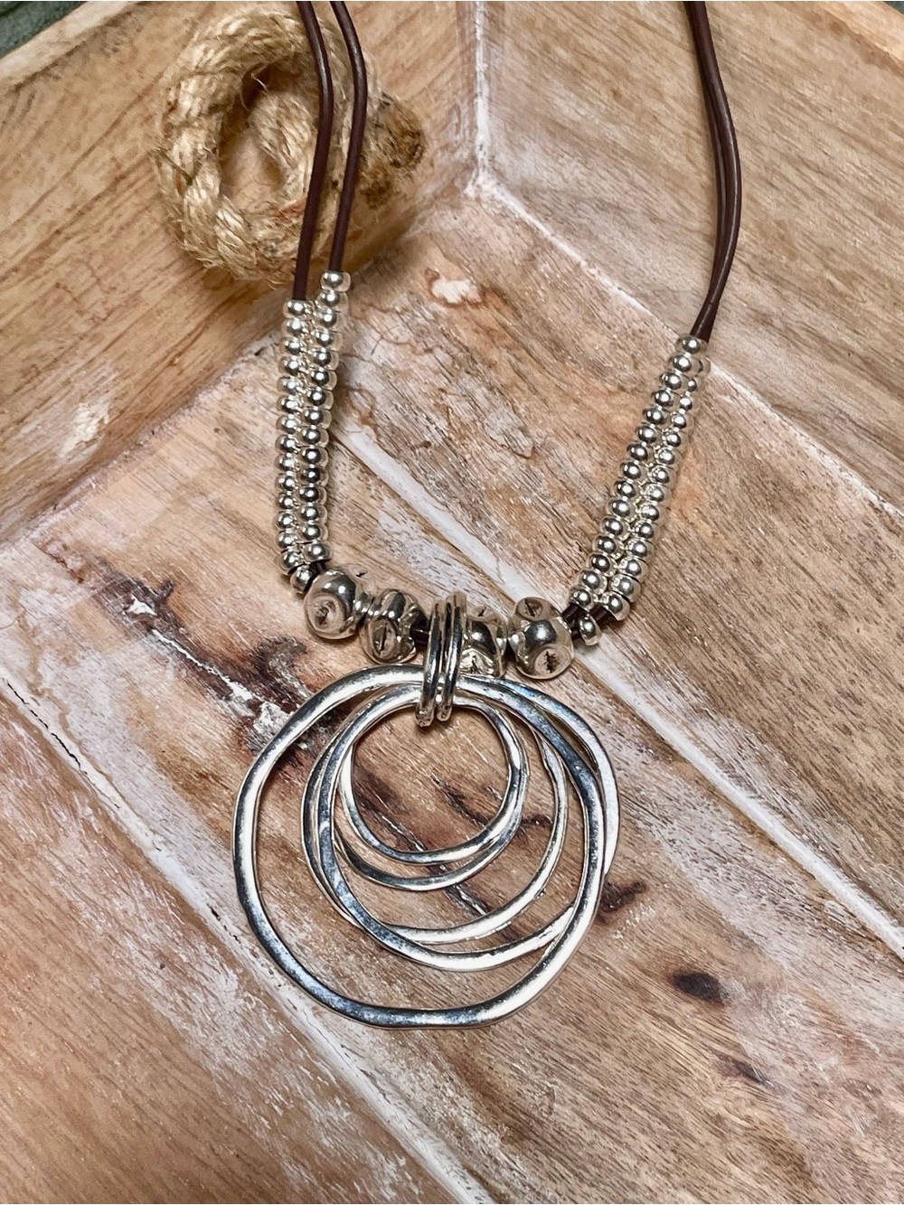 Silver Multi-Ring Pendant Necklace on Brown Cord